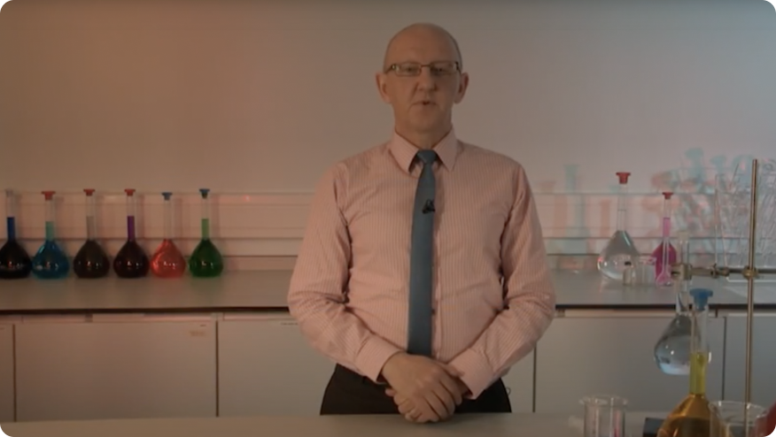  A man standing in front of a table in a lab