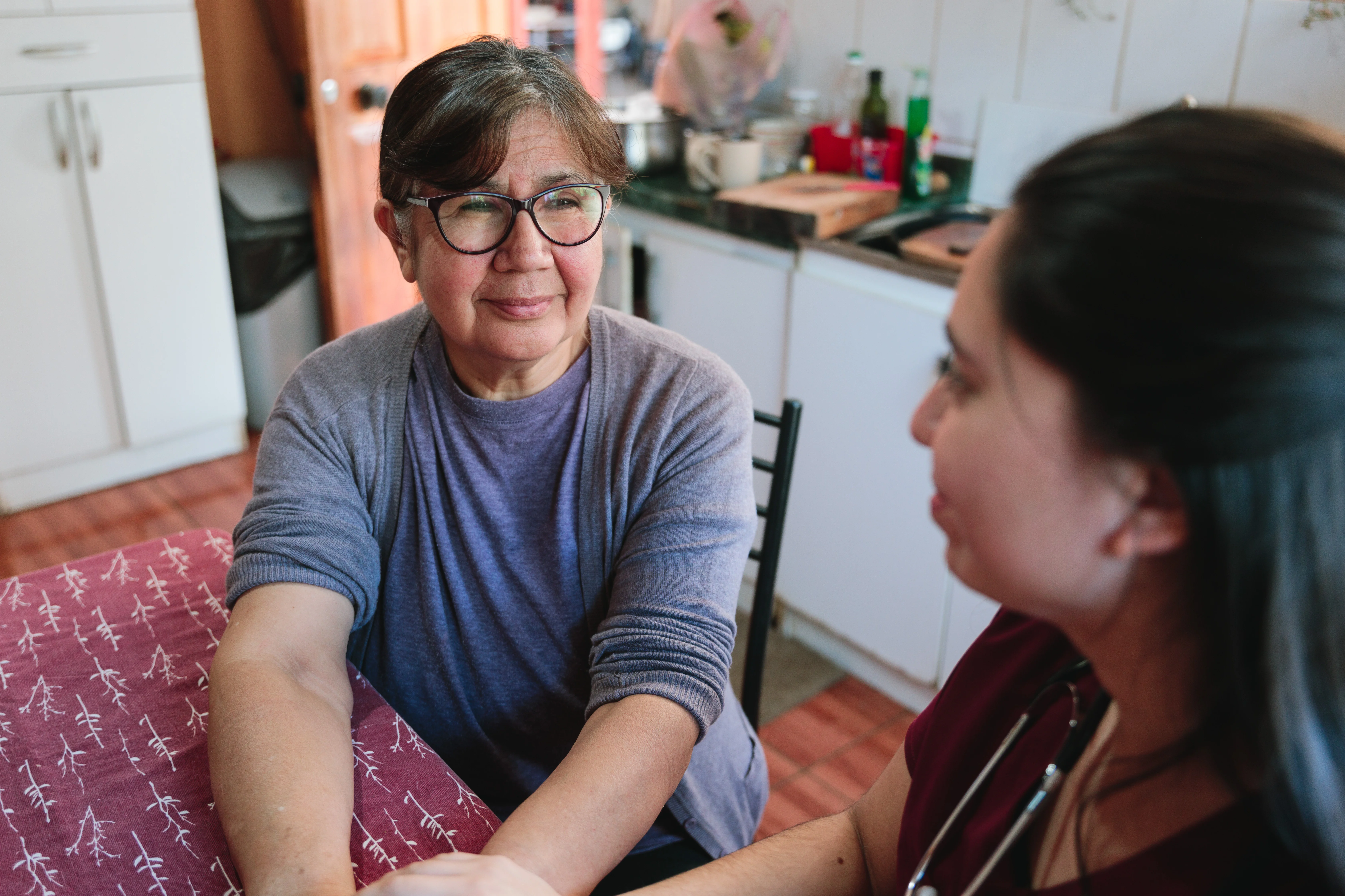 a woman sitting next to a woman