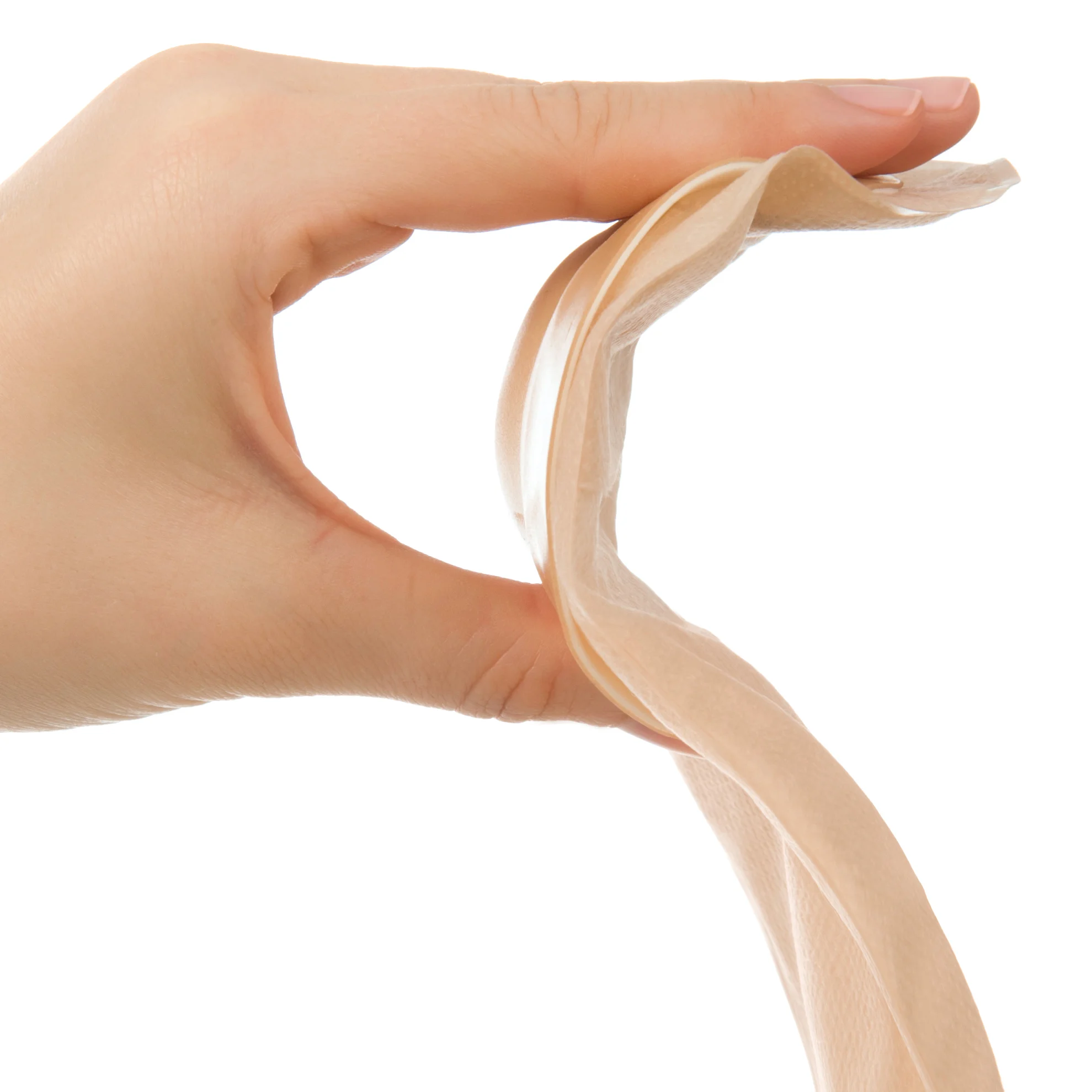 a hand holding an adhesive