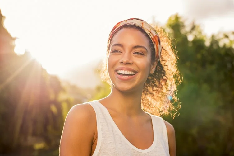a woman smiling with a large headband